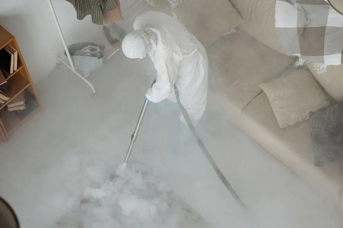 Biohazard cleanup technician in protective equipment, Oak Hills Place, LA
